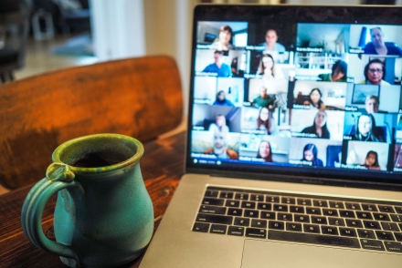 Laptop sitting next to a coffee cup