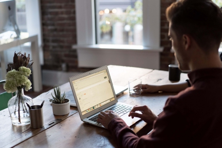 Man in silhouette typing on a keyboard